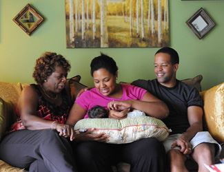 A woman breastfeeding a baby during a breastfeeding counseling session.